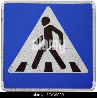 The old weathered cracked enameled international standard road sign - the crosswalk. Isolated Stock Photo