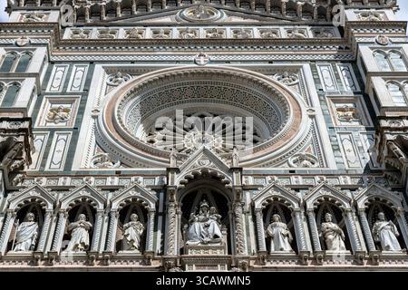 Close-up of rose window and statues on the facade of Florence Cathedral, Tuscany, Italy Stock Photo