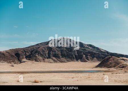 Mount Aso volcanic crater and surrounding grasslands in Kyushu, Japan, featuring dramatic steam plumes, rugged terrain, and panoramic mountain views u Stock Photo