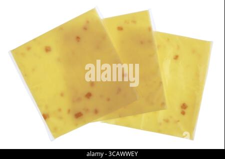 Plates of melted cheese with pieces of bacon in square plastic bags. Isolated on white studio macro shot Stock Photo