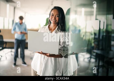 Portrait of a beautiful successful young business people software engineer with laptop in the office Stock Photo
