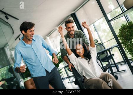 Portrait of overjoyed young diverse employees workers in creative modern office. Team building Stock Photo