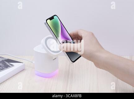 Smartphone placed on a wireless MagSafe charger, emphasizing effortless and modern charging technology for fast and efficient device power-up. Perfect Stock Photo