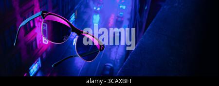 Stylish steampunk-inspired glasses floating mid-air against a dark neon-lit city. Sci-fi atmosphere with glowing elements and dramatic lighting Stock Photo