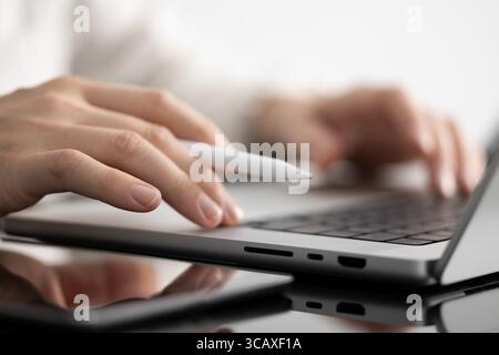 Businessman working on laptop in bright environment. Only hands are visible. Minimalistic and clean setup symbolizing productivity and digital workflo Stock Photo