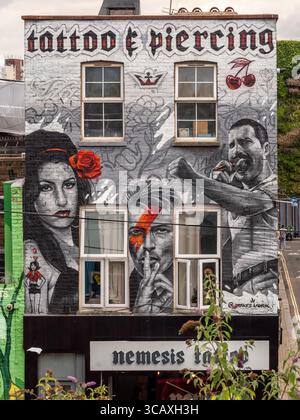 A large street art mural depicting music legends Amy Winehouse, David Bowie, and Freddie Mercury on a building in Camden Town, London, UK. Stock Photo