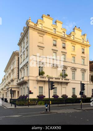 A grand, cream-coloured stucco townhouse on a street corner, an example of the classic, elegant architecture in Belgravia, London, UK. Stock Photo