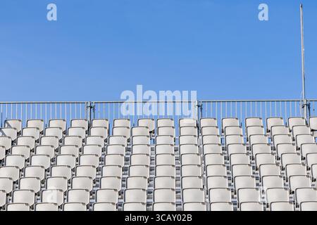 Oslo, Norway - June 16 2025: Empty seat stand with plastic seats and blue sky background. No visible people Stock Photo