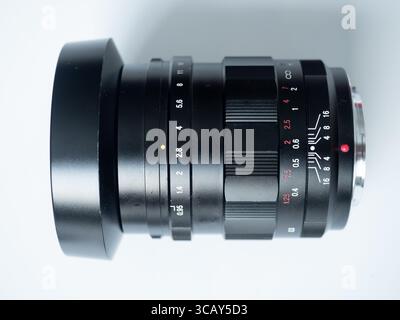 Close-up of professional camera lens with focus and aperture rings on white background Stock Photo