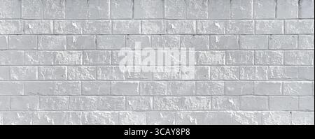 White painted brick wall providing a textured backdrop, ideal for design and architectural projects Stock Photo