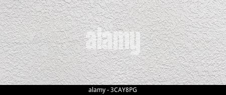 Close-up view of white rough plaster wall creating textured background Stock Photo