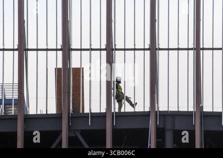 Mesa, Arizona, USA. 7th Aug, 2025. A construction worker moves across the steel frame of the EdgeConneX data center campus, under construction along the Elliot Technology Corridor in Maricopa County. The large-scale project is part of the region's growing footprint in tech infrastructure. Crews remain active as commercial development advances through ongoing record heat in the Phoenix metro area. (Credit Image: © Eduardo Barraza/ZUMA Press Wire) EDITORIAL USAGE ONLY! Not for Commercial USAGE! Stock Photo