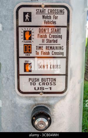 Miami Florida,Biscayne Boulevard,crosswalk pedestrian safety sign,US-1 push button signal instructions,metal traffic post,crossing guide for walkers,i Stock Photo