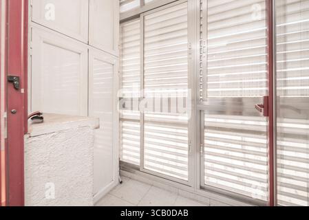 Ultra-thin profile sliding windows in gray aluminum that visually disappear when opened Stock Photo