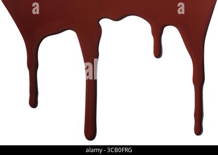 Melted chocolate dripping isolated on white background. Stock Photo