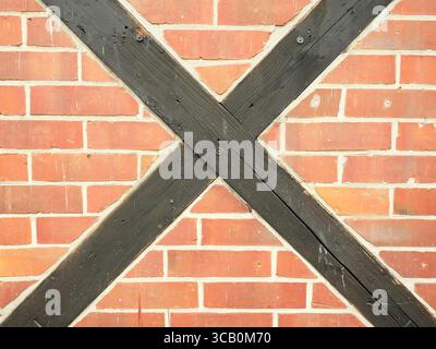 Brick wall with central timber bracing. Historic design detail with decorative effect. Copyspace Stock Photo