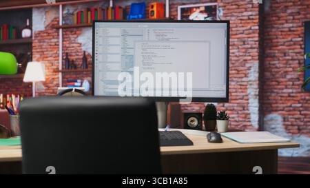 Lines of code written on PC workstation screen on development tool application. Debugging software programming language displayed on computer monitor in living room office Stock Photo