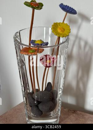 A glass vase filled with an arrangement of colorful flowers Stock Photo ...