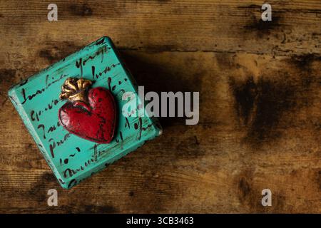 Decorated green jewelry with a red-golden heart Stock Photo