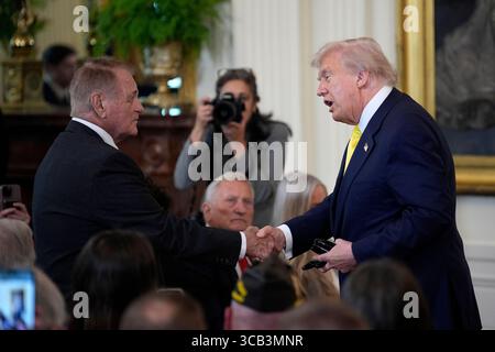 President Donald Trump hands out pizza as he speaks with members of law ...