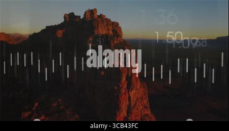 Displaying rocky cliff formation glowing in desert plateau at dusk, with translucent bars overlay Stock Photo