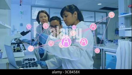 Using pipette scientist wearing blue gloves transferring liquid on lab bench, with network overlay Stock Photo