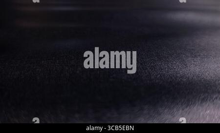 Black leather texture with a subtle, fine grain, perfect for backgrounds, upholstery, and fashion-related content and digital designs. Stock Photo
