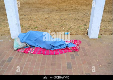 January 5, 2024: Sylhet-Bangladesh: Floating people sleep in the foggy winter  morning on the sidewalk next to the Sylhet Alia Madrasah grounds. Due to the increase in the prices of daily necessities, people are moving from poverty to more poverty, they are moving from villages to cities in search of work. The photo was taken early Friday morning. ....According to the population census in 2011 by the Bangladesh Bureau of Statistics (BBS), the Sylhet population was 479,837. The present population growth rate in Sylhet town is 2.5% per year. Considering 10% floating population comes to the city Stock Photo