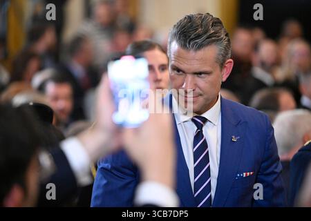 United States Secretary of Defense Pete Hegseth speaks to a colleague ahead of the Purple Heart Ceremony, in the East Room of the White House, in Washington, DC, on Thursday August 7, 2025. Credit: Mattie Neretin/CNP /MediaPunch Stock Photo