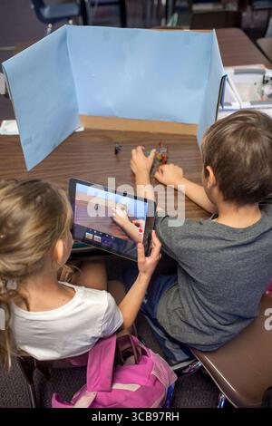 February 19, 2016: Two elementary school students collaborate on a class digital animation project in Mission Viejo, CA. Note desktop background, digital camera, and objects to be animated. (Credit Image: © Spencer Grant/ZUMA Press Wire) Stock Photo
