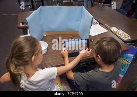 February 19, 2016: Two elementary school students collaborate on a class digital animation project in Mission Viejo, CA. Note desktop background, digital camera, and objects to be animated. (Credit Image: © Spencer Grant/ZUMA Press Wire) Stock Photo