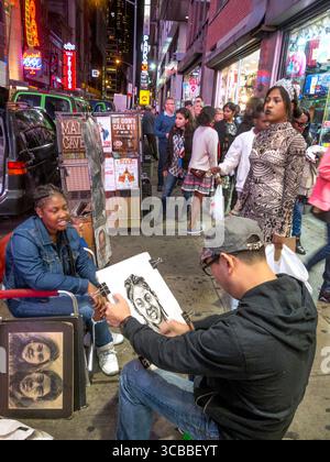 October 7, 2016: An African American young adult poses for an Asian sidewalk portrait artist in Times Square, NY City. Note passerby watching him work and other merchants in background. (Credit Image: © Spencer Grant/ZUMA Press Wire) Stock Photo