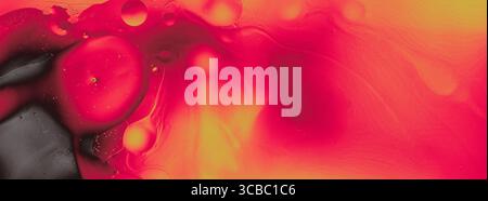 Abstract red and orange liquid texture with bubbles and black accent. Vivid and dynamic modern background in macro view. Stock Photo