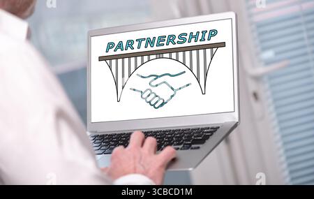 Partnership concept shown on a laptop used by a man Stock Photo