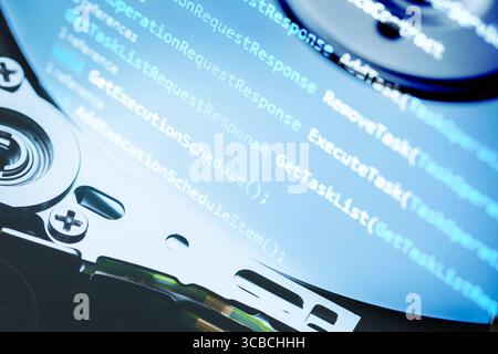 Information technology concept. Coding programmer language script text on hard disk drive. Programmer occupation job Stock Photo