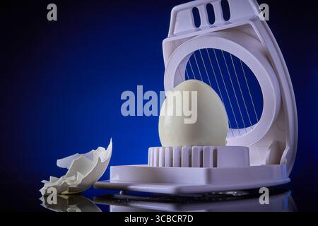 Boiled egg and egg slicer Stock Photo
