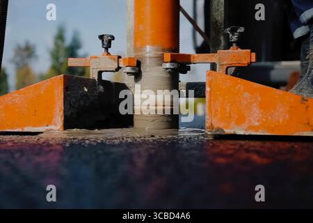 Preparation of asphalt from crushed stone and bitumen resin Stock Photo ...