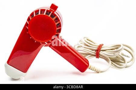 Vintage red plastic hair dryer isolated on white background Stock Photo