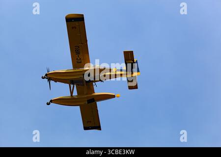 Viana do Castelo, Portugal - July 29, 2025: Yellow Air Tractor AT-802F Fire Boss EC-MRU amphibious firefighting aircraft in the air preparing to scoop Stock Photo