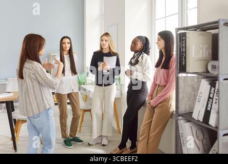 Businesswomen meeting together in office, listening attentively their business leader having seminar Stock Photo