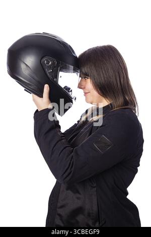 Forty year old woman, wearing a motocycle jacket, holding a motocycle helmet to her head, isolated on a white backgroind Stock Photo