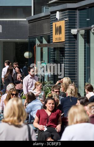 Office workers enjoying lunch break at outdoor seating of Bean Coffee and Cocktails, Liverpool city centre, England, UK. Stock Photo