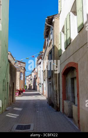 Old traditional houses with colorful façades and shutters, in a narrow street of Veynes, France, a small town in the French department of Hautes-Alpes Stock Photo