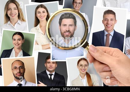Recruiter looking at candidate's photo through magnifying glass, closeup. Human resources management Stock Photo
