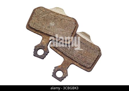 Used bicycle brake pads placed on white background, isolated. Demonstration of their design and wear, suitability for cycling. Concept of bicycle part Stock Photo