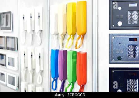 Colored handsets, control panels and intercom monitors on display in a store Stock Photo