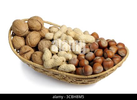 Walnuts, hazelnuts and peanuts in a wicker basket on a white background, isolated Stock Photo