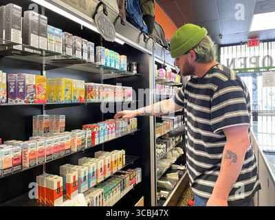 Dillon Carey, an employee of the Magma Vape Smoke Shop, takes inventory of  the store's flavored tobacco products before taking them off the shelf on  Wednesday in Citrus Heights, California. (Maya Miller/The
