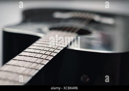 Dark acoustic guitar. Musical instrument. Close up Stock Photo