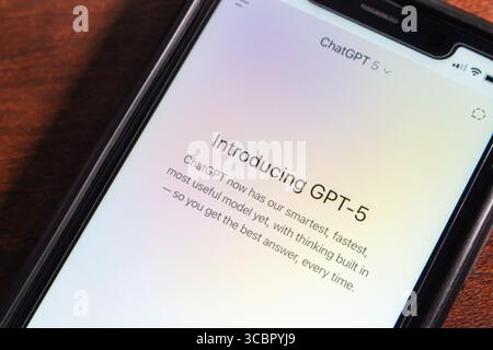 Close-up of a smartphone screen showing the GPT-5 introduction message in the ChatGPT app, highlighting its advanced AI capabilities. Stock Photo